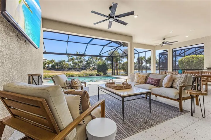 View of patio / terrace with outdoor seating, glass enclosure, ceiling fan, and a sunroom