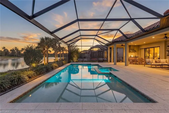 Integrated pool / hot tub with glass enclosure, a sunroom, a patio area, and an outdoor lounge area