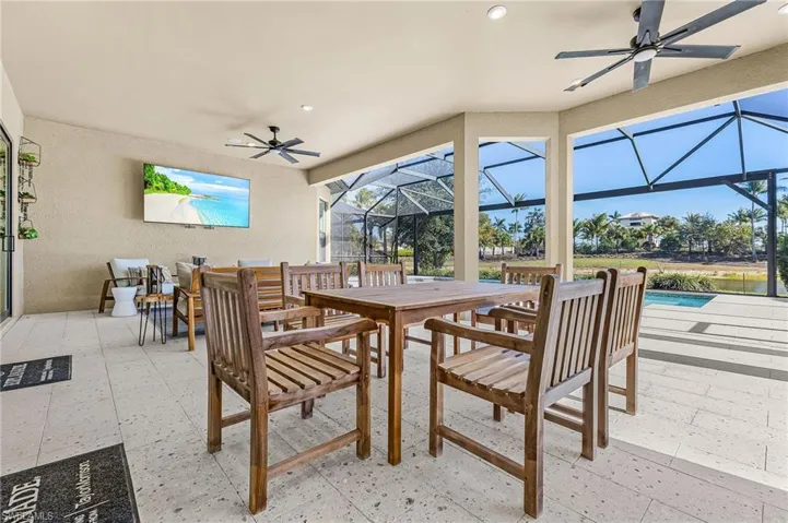 View of patio / terrace featuring ceiling fan, outdoor dining area, glass enclosure, a sunroom, and an outdoor pool