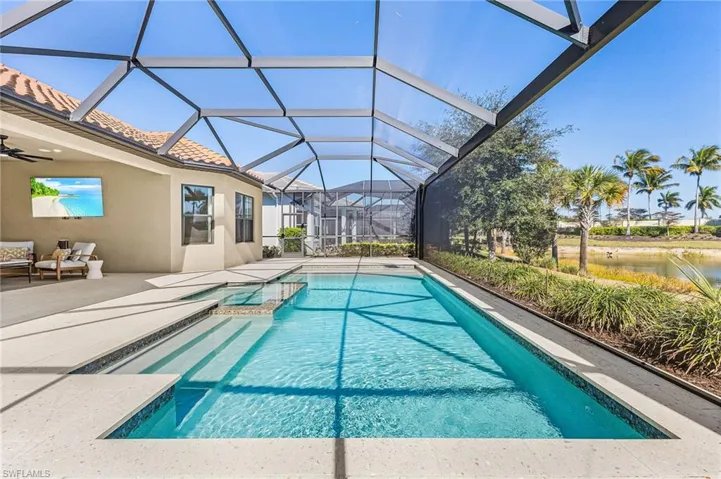 Integrated pool / spa with a sunroom, a patio, a lanai, and an outdoor living space