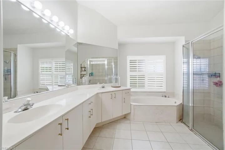 Primary bath featuring dual sinks, a soaking tub and separate shower.
