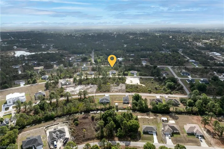 Aerial overview of property's location featuring nearby suburban area