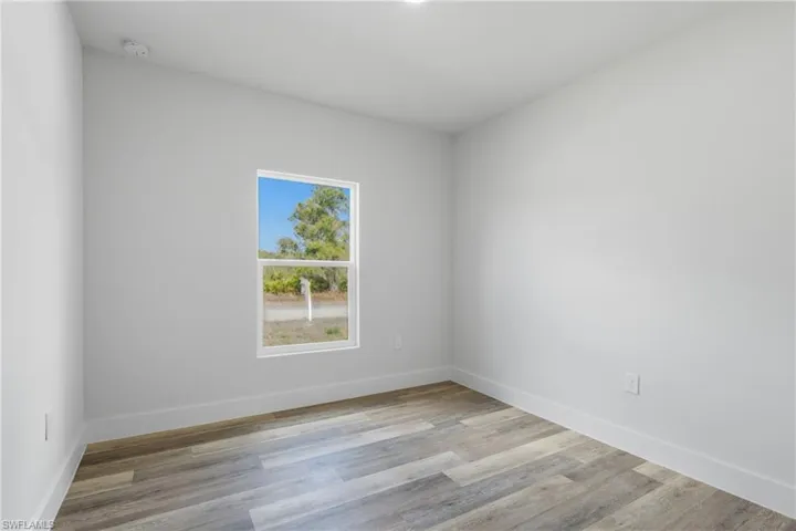Empty room featuring light wood-type flooring and baseboards