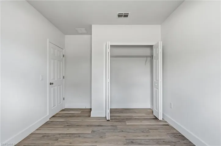 Unfurnished bedroom featuring light wood finished floors and a closet