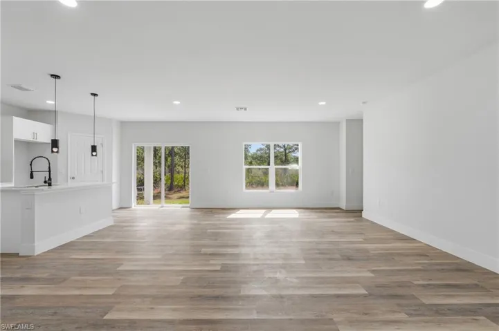 Unfurnished living room with recessed lighting and light wood-style flooring