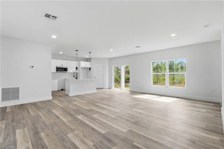 Unfurnished living room with light wood-style floors and recessed lighting
