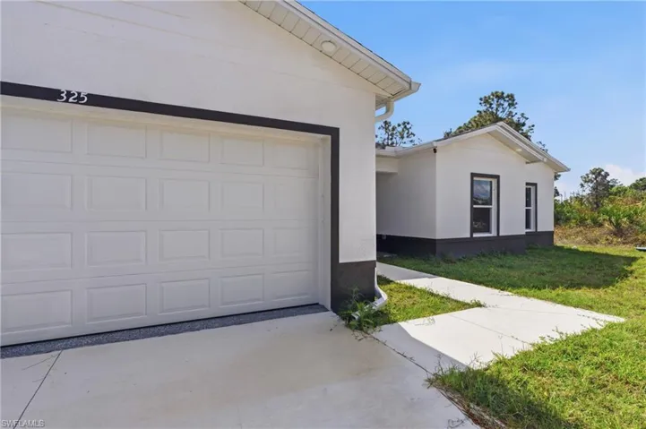 Garage featuring concrete driveway