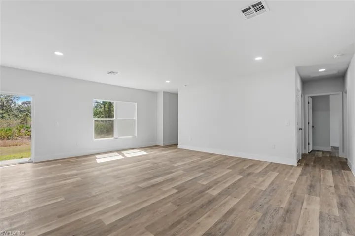 Unfurnished living room featuring light wood finished floors and recessed lighting