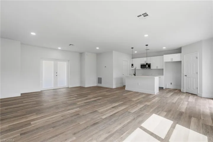 Unfurnished living room featuring light wood finished floors and recessed lighting