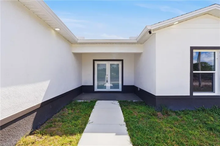 Entrance to property with french doors and stucco siding
