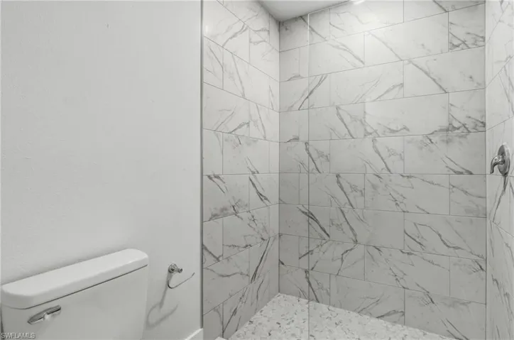 Full bathroom featuring tiled shower