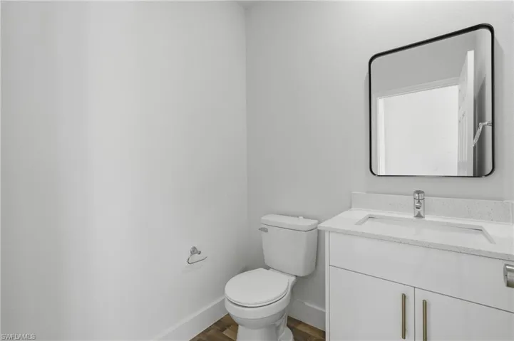 Bathroom with vanity and dark wood-style flooring