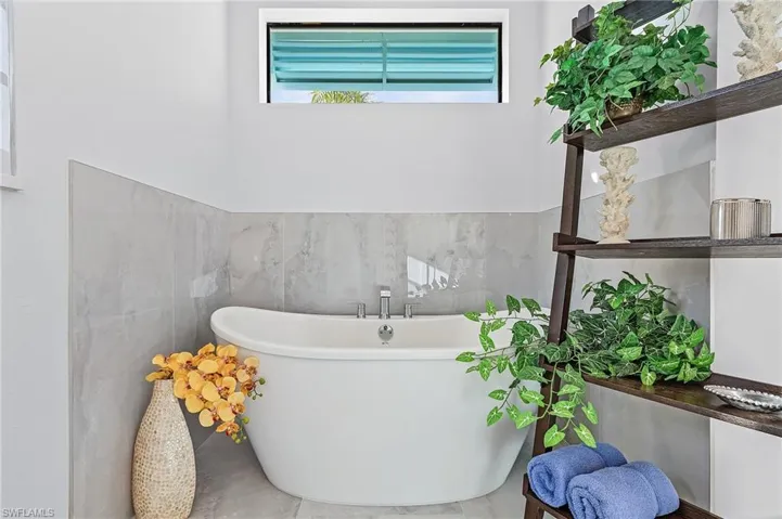 Bathroom with a bathtub and tile walls
