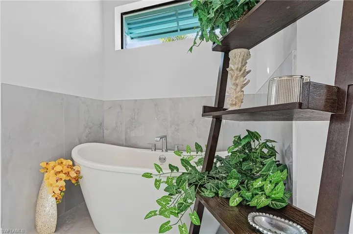 Bathroom featuring concrete floors and a bath