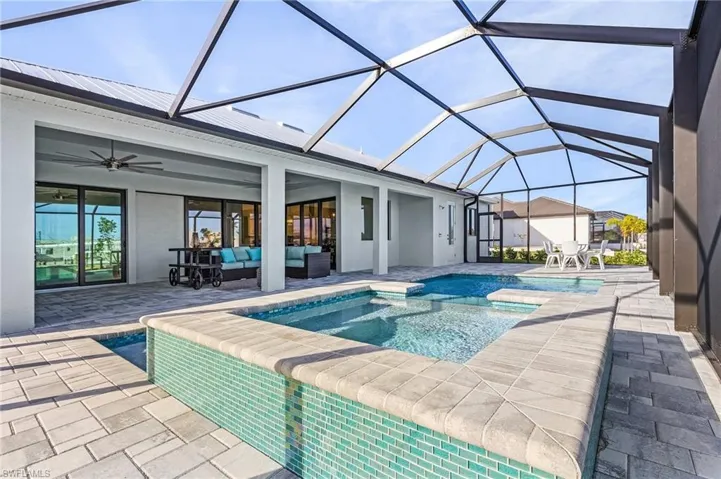 View of swimming pool with a patio, ceiling fan, a lanai, and an outdoor hangout area