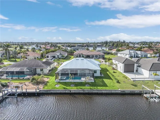 Birds eye view of property with a water view