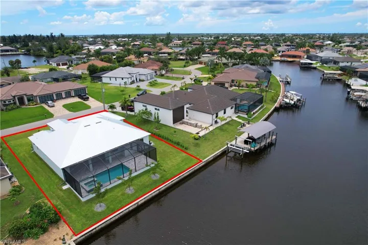 Birds eye view of property with a water view