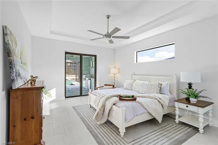 Bedroom featuring ceiling fan, access to outside, and multiple windows