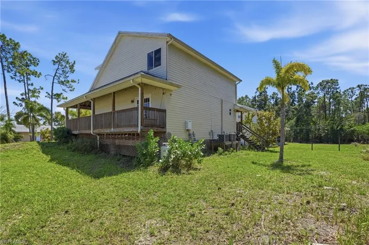 View of home's exterior with a yard