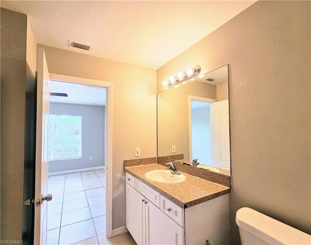 Bathroom with vanity and light tile patterned floors