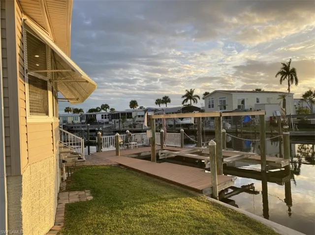 View of dock with a lawn
