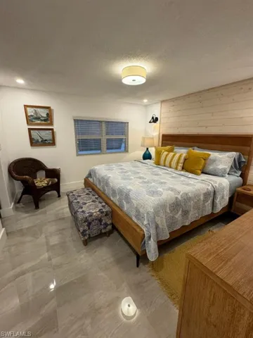 Tiled bedroom with a textured ceiling and wooden walls