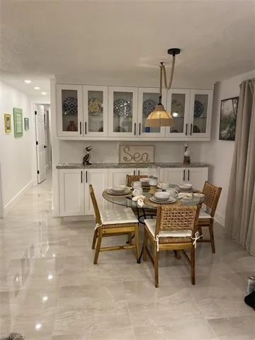 Tiled dining room with a textured ceiling