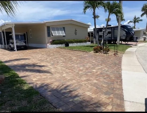 View of front of property with a carport