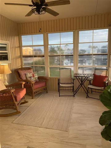 Sunroom with a healthy amount of sunlight and ceiling fan