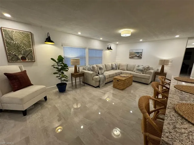 Living room with tile floors and a textured ceiling