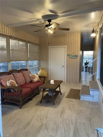 Living room featuring tile floors and ceiling fan