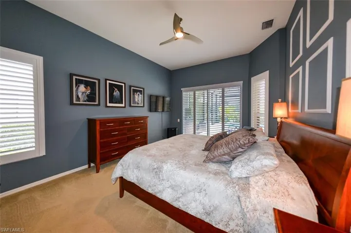 Carpeted bedroom with ceiling fan