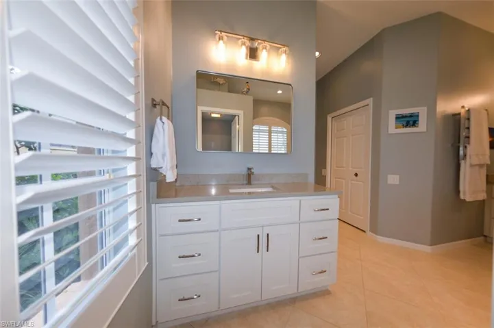 Bathroom featuring tile floors and vanity