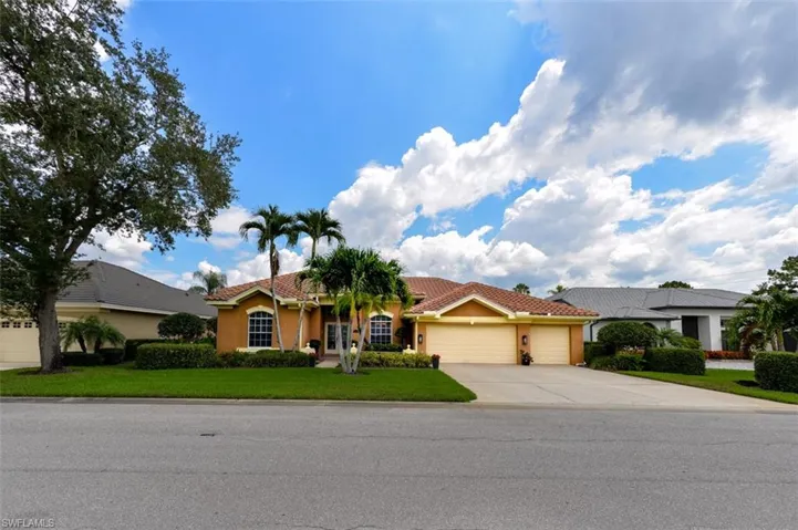 View of front of house with a garage and a front lawn