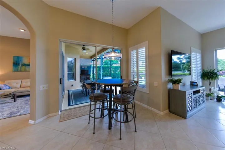 Tiled dining space featuring ceiling fan
