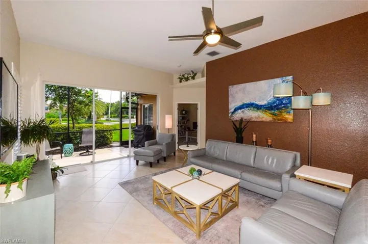 Living room featuring ceiling fan and tile floors