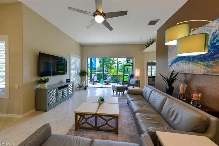 Living room featuring tile floors and ceiling fan