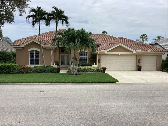 Mediterranean / spanish home with a garage and a front lawn