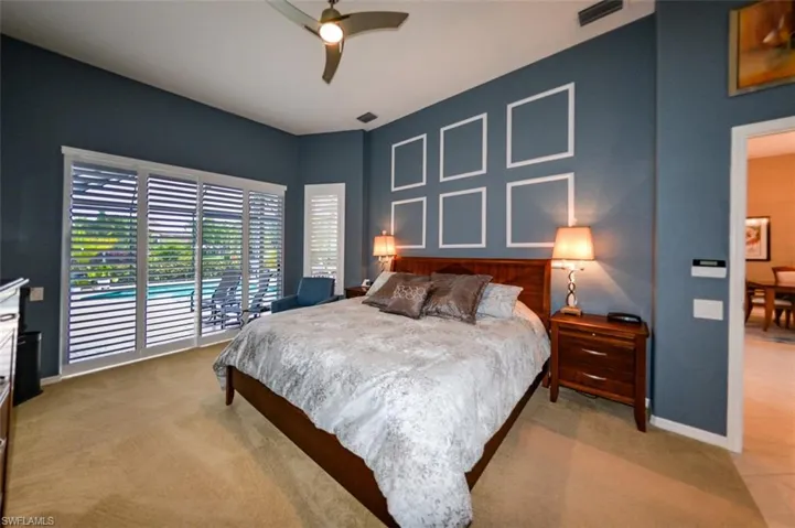 Bedroom with carpet flooring, ceiling fan, and access to exterior