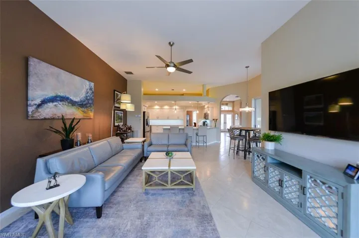 Living room featuring ceiling fan and light tile floors