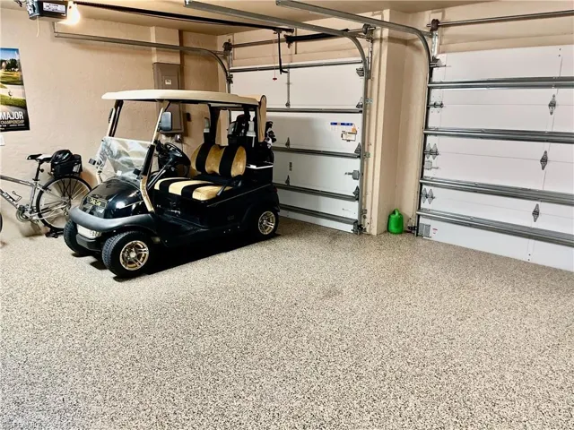 A 3-car garage featuring an Epoxy Floor & Extra Storage