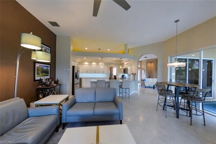 Living room featuring ceiling fan and light tile floors