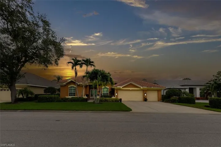 Ranch-style house with a garage and a yard at sunset. Virtual Sunset.