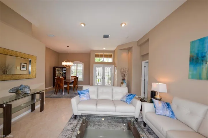Living room with an inviting chandelier and light tile floors
