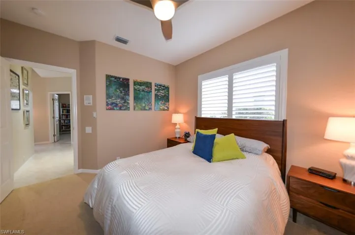 Carpeted bedroom with ceiling fan
