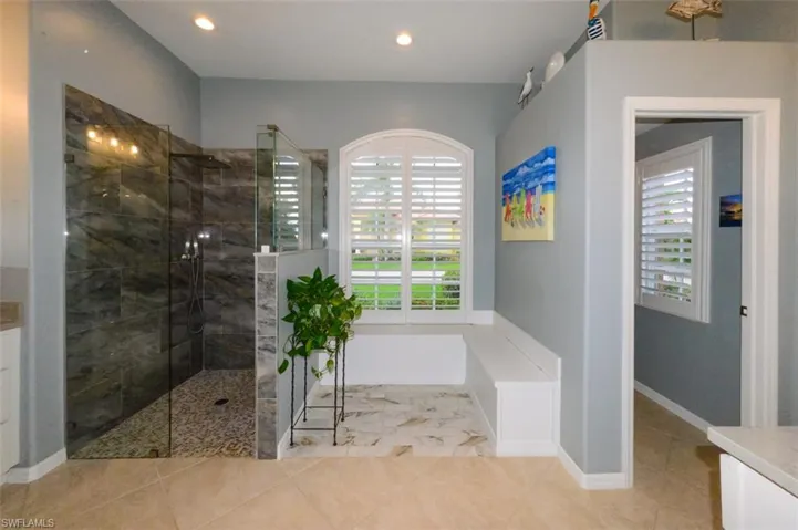 Bathroom with a healthy amount of sunlight, vanity, and tile floors