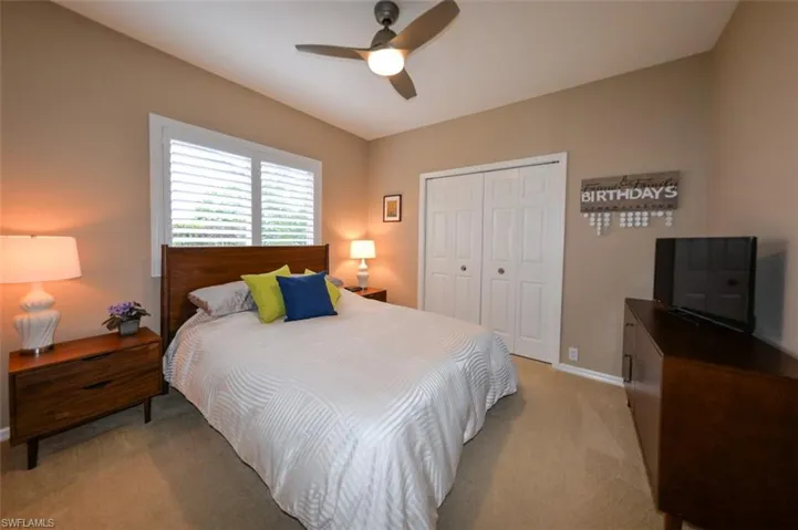 Bedroom featuring a closet, ceiling fan, and carpet floors