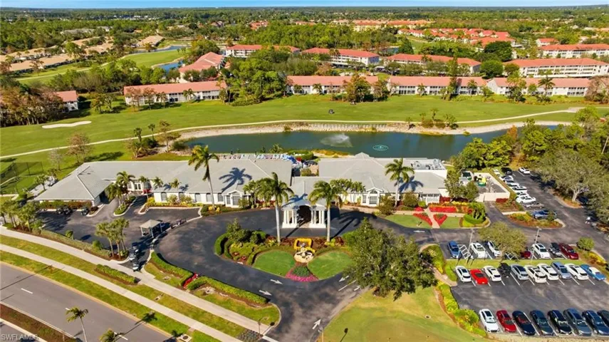 Drone / aerial view of a local golf course and a nearby body of water
