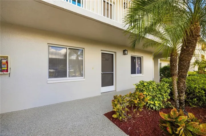 Entrance to property with stucco siding