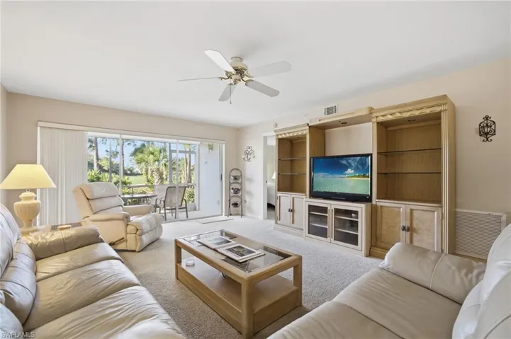 Living area featuring carpet and a ceiling fan